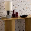 A console table with decorative items on it, set against a terrazzo-patterned wall. Anteprima dell’immagine prodotto