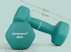 Two teal dumbbells are shown on a light teal background, with dimensions indicated by lines and text. Produktbild-Vorschau