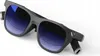 A pair of futuristic sunglasses with blue tinted lenses, shown from a slightly elevated angle against a white background. Anteprima dell’immagine prodotto