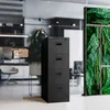 A black filing cabinet with four drawers is shown in an office setting, with glass walls and greenery in the background. Anteprima dell’immagine prodotto