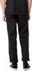 A person wearing black Dickies work pants and black Vans sneakers, shown from the back. Náhled obrázku produktu