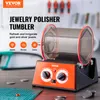 A jewelry polisher tumbler is shown on a table with some coins and a cutting mat. Náhľad obrázku produktu