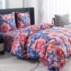 A bed with floral patterned bedding. Náhled obrázku produktu