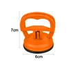 An orange suction cup tool with dimensions indicated by text. Produktbild-Vorschau