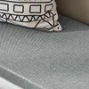 A close-up of a gray upholstered bench seat with a patterned pillow resting on it. Náhľad obrázku produktu