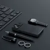 A collection of office and personal accessories arranged on a dark surface. Produktbild-Vorschau
