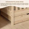 Close-up view of the lower section of a wooden bed frame, highlighting adjustable legs and a drawer. Produktbild-Vorschau