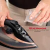 A person is pouring water into an iron. Produktbild-Vorschau