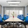 A modern office meeting room with a long table and blue chairs, illuminated by ceiling lights. Produktbild-Vorschau