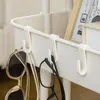 Close-up of a white serving cart with hooks holding sunglasses and eyeglasses. A framed picture is visible in the background. Náhled obrázku produktu
