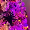A close-up of a Halloween-themed tree decorated with purple and orange lights and a black spider ornament. Produktbild-Vorschau