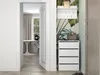 A hallway with a shoe cabinet, coat rack, and a doorway leading to another room. Podgląd zdjęcia produktu