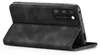 A black flip case for a smartphone is shown from a side angle, with the phone inserted and the cover folded back. Produktbild-Vorschau