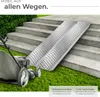 Two metal ramps are placed on concrete stairs, with a lawnmower in the foreground. Náhled obrázku produktu