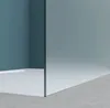 A minimalist interior scene showing a corner of a shower enclosure with a white base and a glass wall. Produktbild-Vorschau