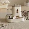 A cat is eating from an automatic pet feeder that dispenses food and water. Produktbild-Vorschau