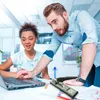 Two people are looking at a laptop in an office setting. Náhľad obrázku produktu