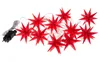 A string of red star-shaped LED lights with a black plug on a white background. Produktbild-Vorschau