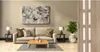 A living room scene with a sofa, coffee table, artwork, and a folding door. Podgląd zdjęcia produktu