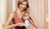 A woman is using a Philips hair dryer with a diffuser attachment on her wavy blonde hair. Náhled obrázku produktu