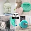 A collage of four images showcasing different silicone molds and cast items, including a Buddha head, hearts, a lion head, and a cylindrical mold with a rope. A central overlay highlights versatility. Produktbild-Vorschau