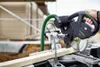 A person is using a Festool miter saw to cut a piece of wood outdoors. Podgląd zdjęcia produktu