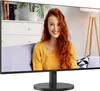 A woman is shown on a computer monitor screen, sitting on a couch in a living room setting. Náhled obrázku produktu
