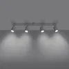 A ceiling light fixture with four adjustable spotlights is mounted on a gray ceiling, casting shadows on a gray wall below. Podgląd zdjęcia produktu
