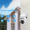 A security camera is mounted on a wall, with a house in the background. Feature icons are displayed on the left. Podgląd zdjęcia produktu