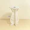 A white decorative plant stand is shown against a light-colored background. Produktbild-Vorschau