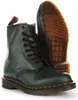 A pair of green Dr. Martens boots shown from the front and side, with the sole of one boot prominently displayed. Produktbild-Vorschau