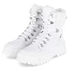 A pair of white winter boots with white laces and white fur trim, shown from a slightly angled front view on a white background. Podgląd zdjęcia produktu