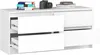 A white dresser with four drawers, two of which are open, on a white background. A stack of books and a camera are on top of the dresser. Produktbild-Vorschau