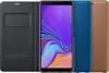 A Samsung Galaxy A7 (2018) smartphone with a black booktype case and two other cases in blue and brown. Produktbild-Vorschau