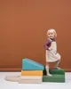A young child is playing on a set of colorful foam climbing blocks. Anteprima dell’immagine prodotto