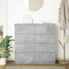 A dresser with a concrete-like finish is shown in a room with a plant and a coat rack. Náhled obrázku produktu