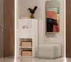 A hallway vignette featuring a white storage cabinet, a stool, and a framed abstract painting. Náhled obrázku produktu