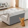A kitten is playing near a sofa with a scratch protector attached to its side. Produktbild-Vorschau