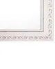 A close-up of the corner of a rectangular mirror with a decorative white frame. Náhled obrázku produktu