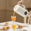 A person is pouring orange juice from a white appliance into two glasses on a table set for breakfast with pastries and eggs. Podgląd zdjęcia produktu