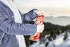 A person holding a product in a snowy, mountainous environment. Náhľad obrázku produktu