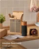 A salt and pepper grinder set is displayed on a wooden countertop, with its packaging and instructions nearby. Produktbild-Vorschau