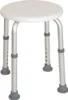 A white round shower stool with adjustable silver legs and gray rubber feet, isolated on a white background. Produktbild-Vorschau