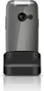 A flip phone is shown in its charging dock against a white background. Podgląd zdjęcia produktu