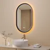 A modern bathroom vanity with a sink, faucet, and an illuminated oval mirror. Produktbild-Vorschau