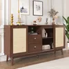 A wooden sideboard with rattan doors and drawers, decorated with various items on top. Produktbild-Vorschau