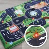 A play mat for children featuring a city road network with various buildings and vehicles. Podgląd zdjęcia produktu