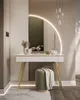 A modern vanity table with a large illuminated mirror, a stool, and decorative items. Produktbild-Vorschau