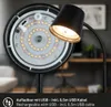 Close-up of the back of a black LED desk lamp, showing the LED ring and a USB port, with a blurred office background. Náhľad obrázku produktu