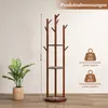 A wooden coat rack with shelves and hooks, shown with dimensions and weight capacity information, next to a potted plant. Anteprima dell’immagine prodotto